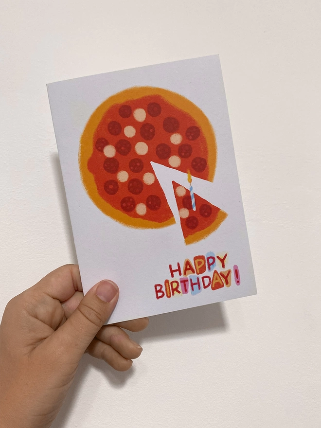 pizza birthday card in hand