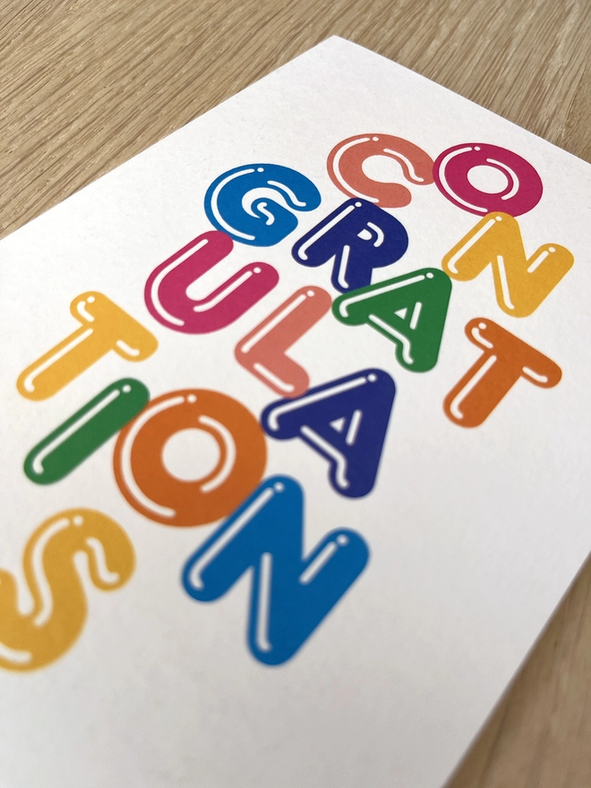 Typographic congratulations card in bright colours