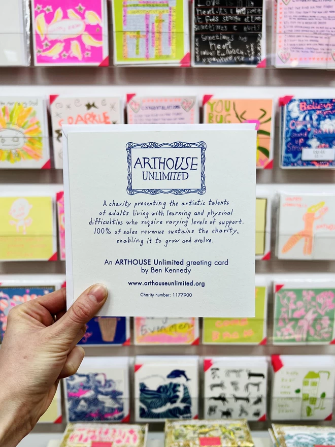 Back of A new baby card featuring the Arthouse Unlimited logo printed in deep blue with cards behind 