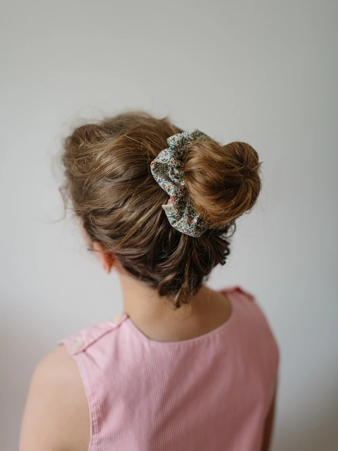 Girl wearing a liberty of london Hair scrunchie by Runaround Retro