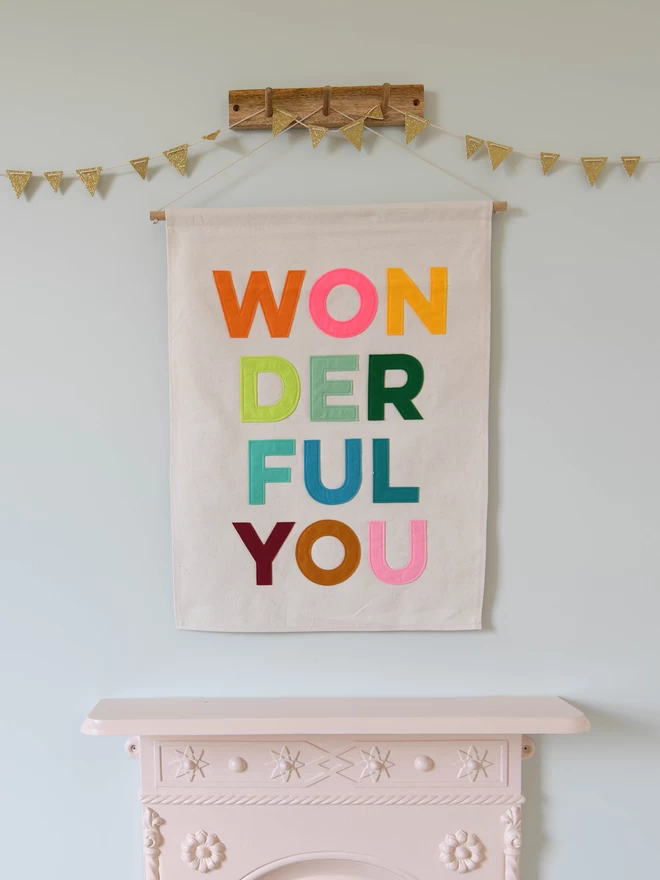 fabric banner with wonderful you sewn on in bright felt letters.