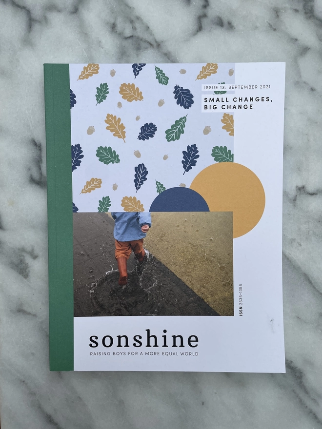 Sonshine Magazine Issue 13. Small changes, Big Change a paper magazine featuring a photograph of a toddler splashing in a puddle 