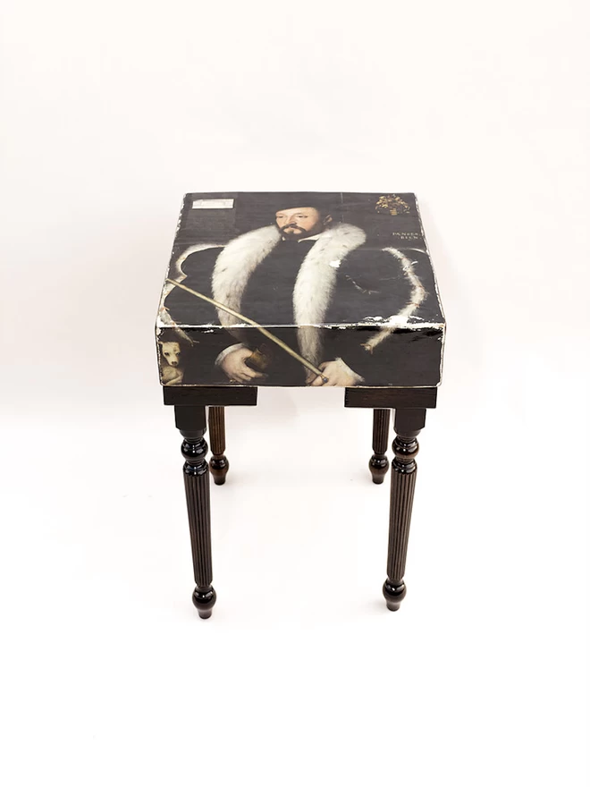 square tall side table with image of man on top
