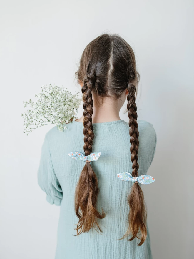 girl with set of two liberty hair bobbles and flowers