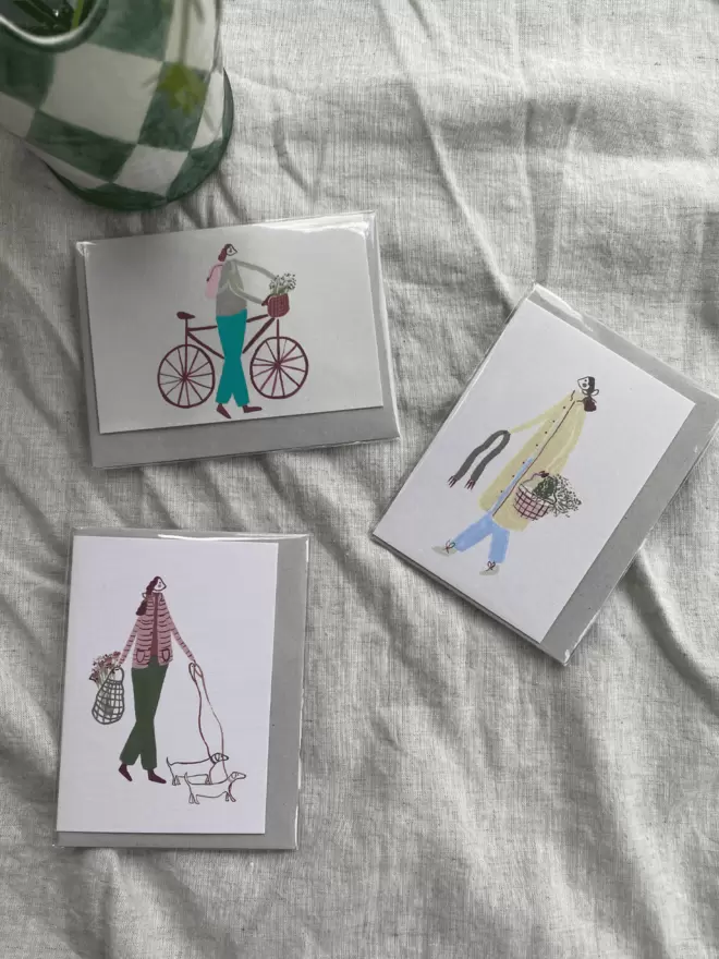 greetings cards with little people one, biking, walking the dog and foraging flowers