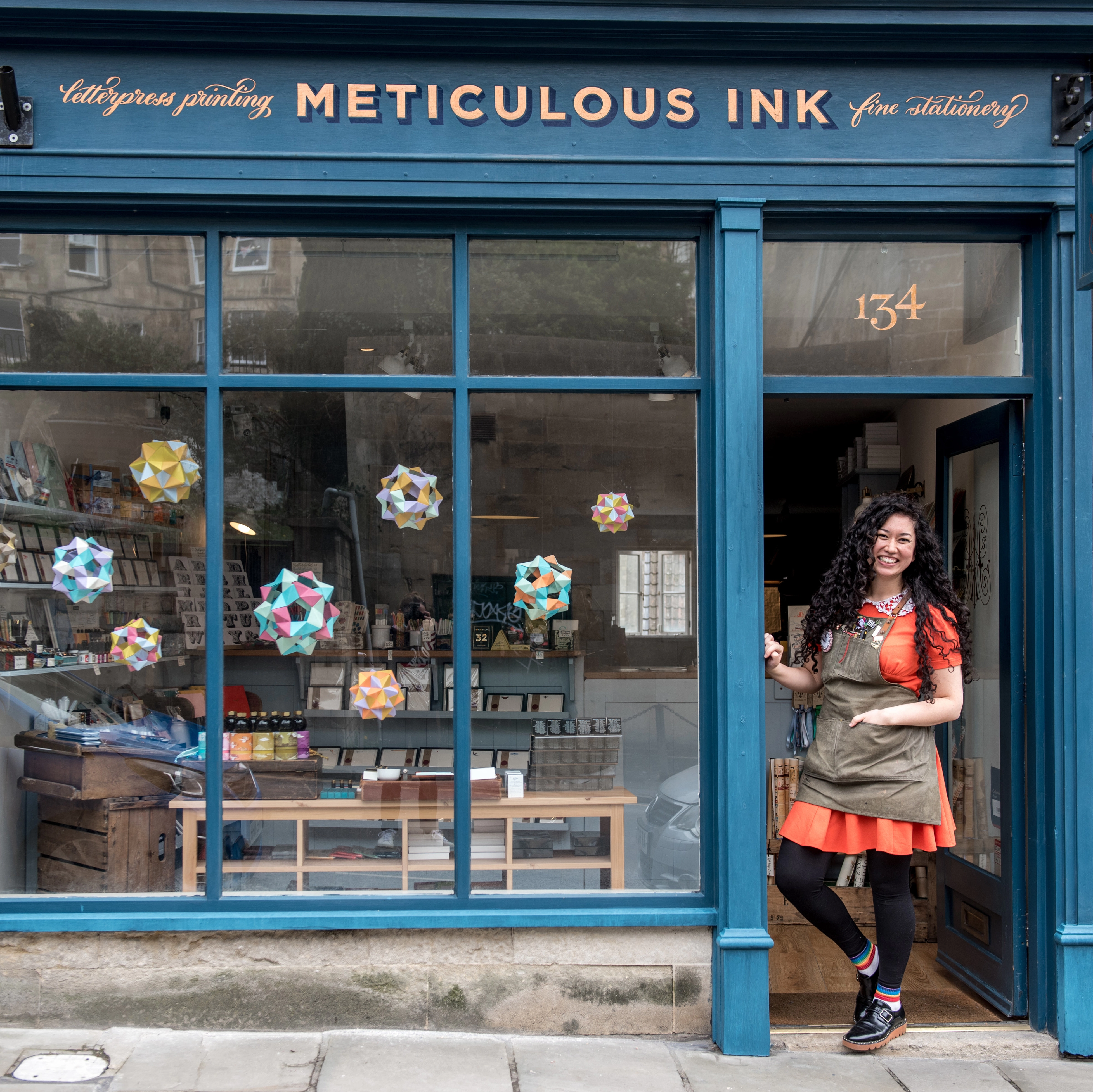 Athena standing in front of the Meticulous Ink shop