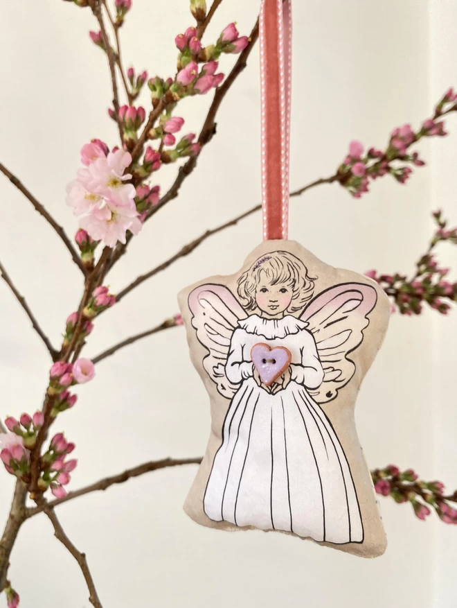 pretty fairy holding a clay heart shaped lilac button