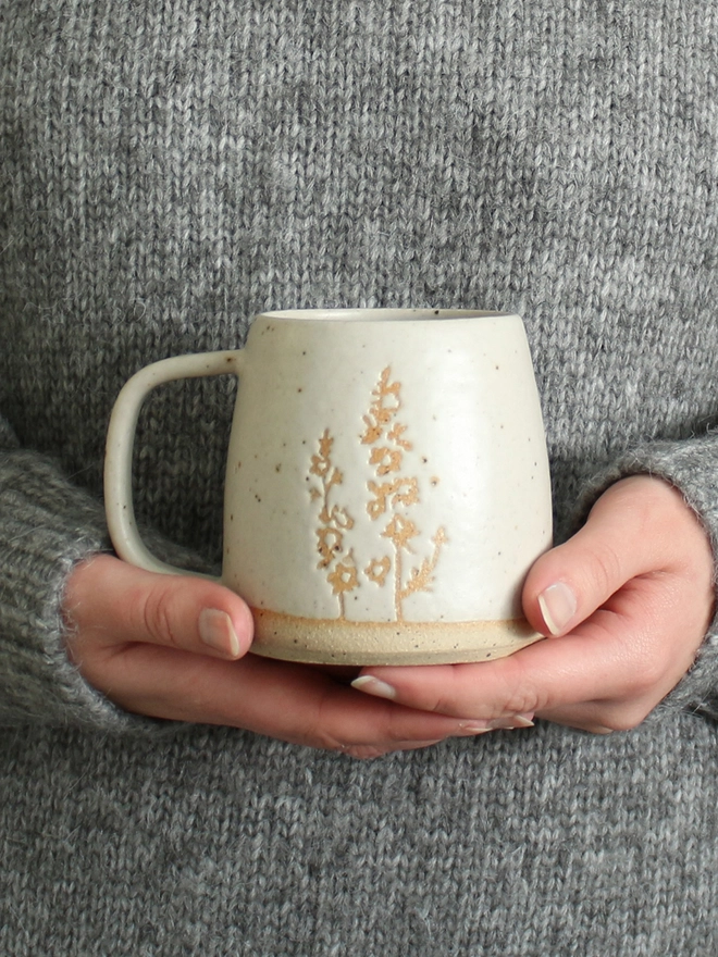 Hands holding Larkspur mug
