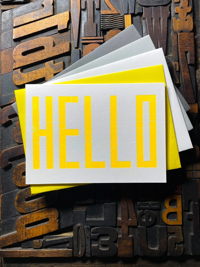 A card to just say HELLO and send to family and your friends.   Made from a grid of square wooden type blocks. Printed using fluorescent yellow ink with a deep impression print. Luxurious Colorplan Pristine White thick 350gsm double-sided card.