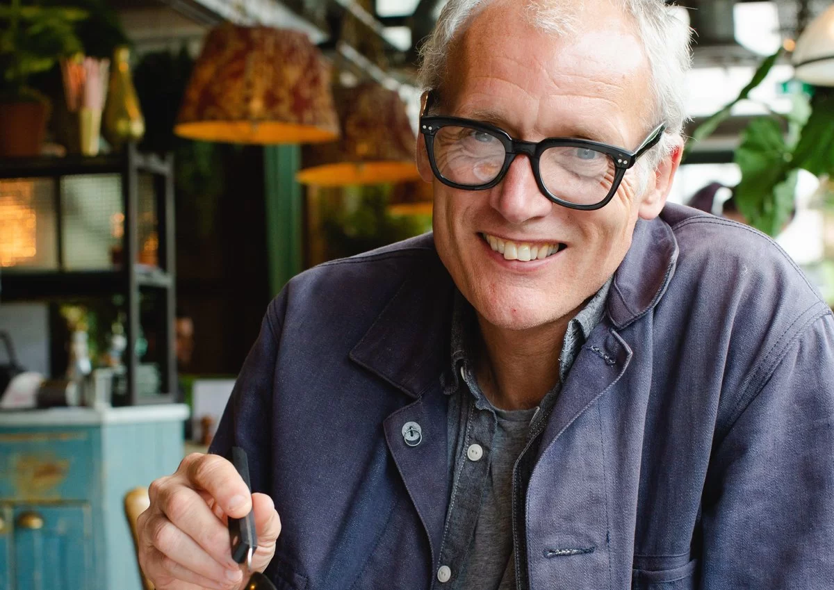 Bill Collison, founder of Bills, smilling at the camera in a blue demin jacket.