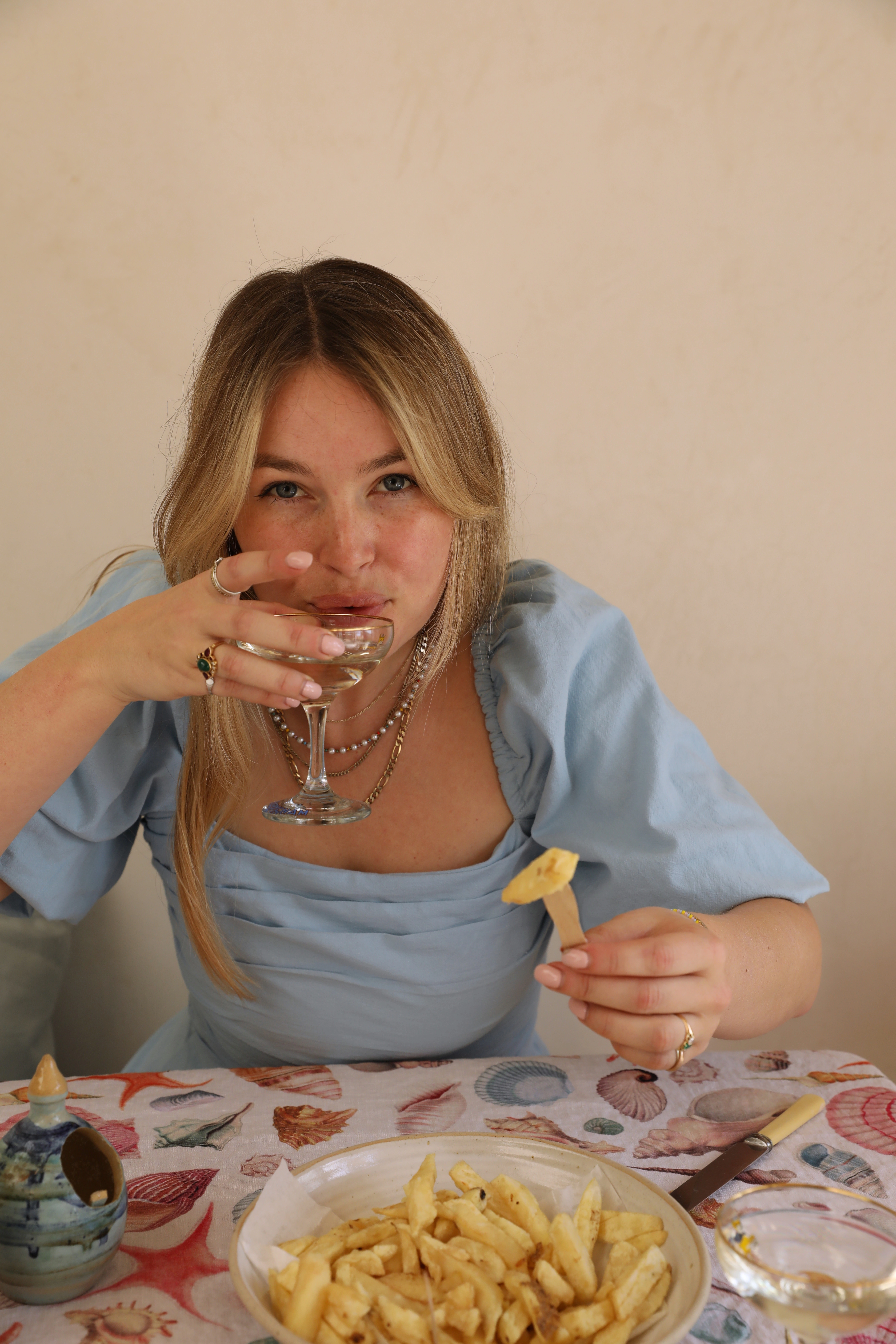 girl at table with chips and champagne