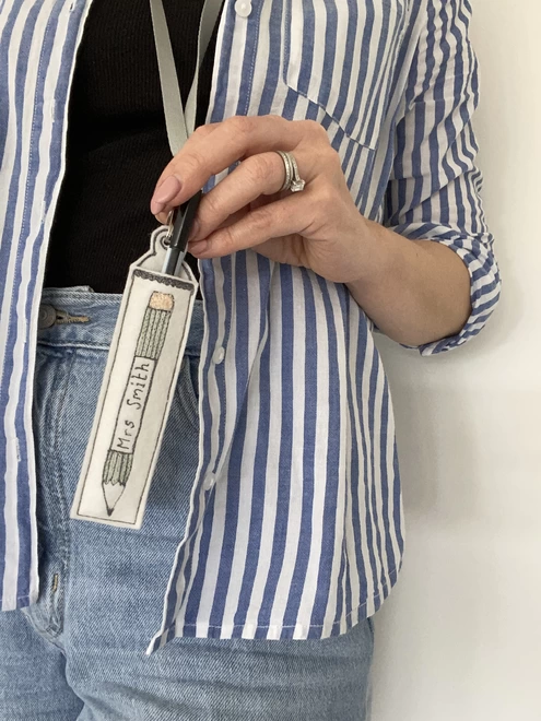 Personalised Teachers Pen Holder Lanyard being held by person in stripe shirt