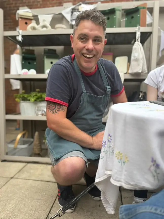 Made in the Malthouse maker sitting and smiling away from camera