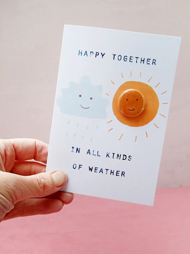 sunny weather card with pin badge