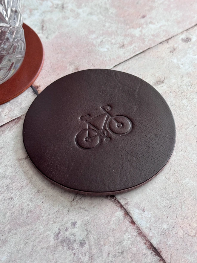 Leather coaster with bike deboss