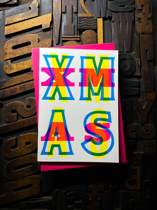 Festive Christmas typographic letterpress card with deep impression print. Very colourful and vibrant. With Hot Pink envelope.