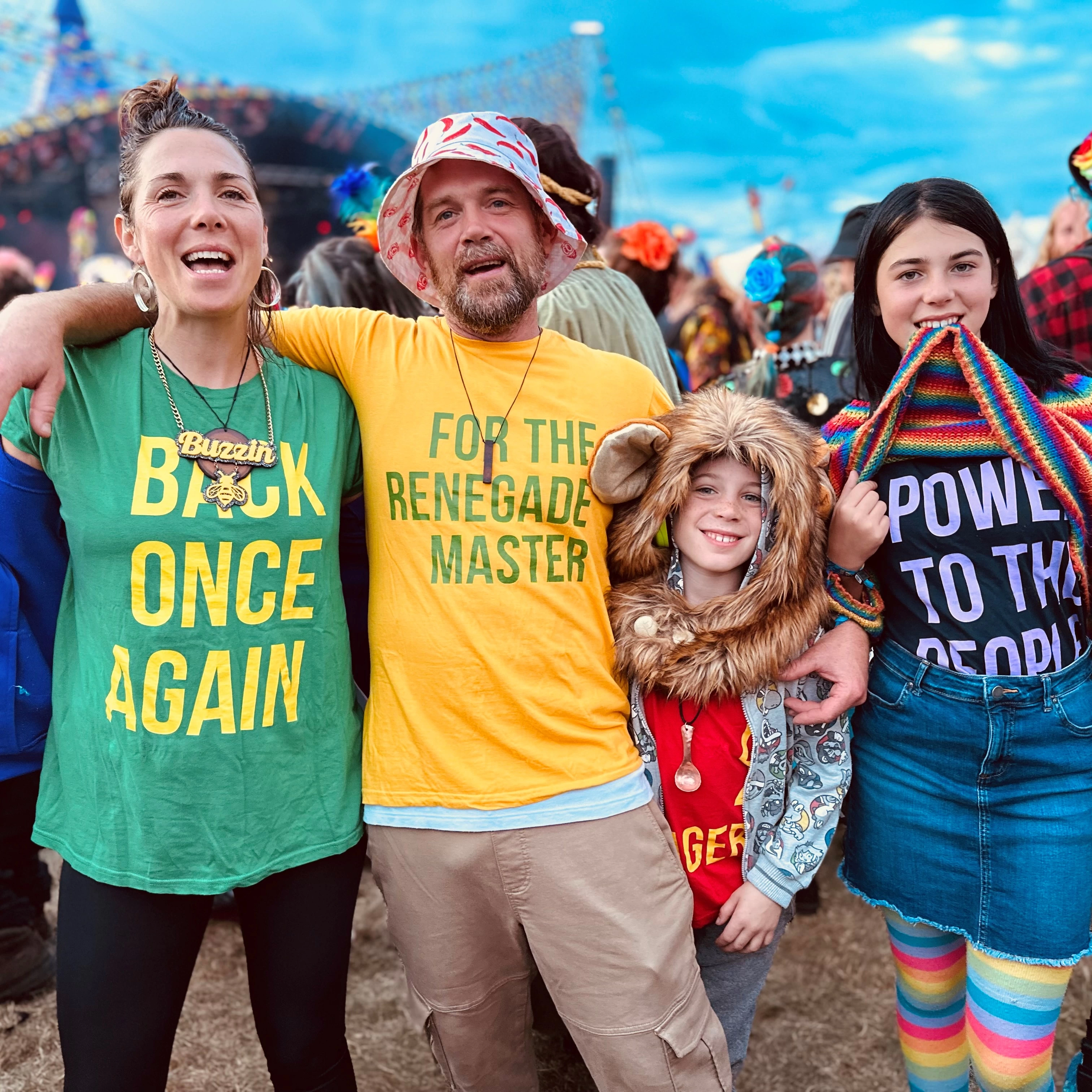 Picture of Muti the founder of Muti with his wife & two kids at a festival wearing their family shirts that read "Back Once again" "For the renegade master" "D for Damager" & "Power to the people"
