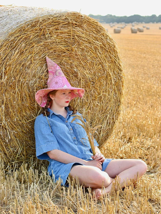 Girl wearing a witch hat handmade from upcycled vintage fabric