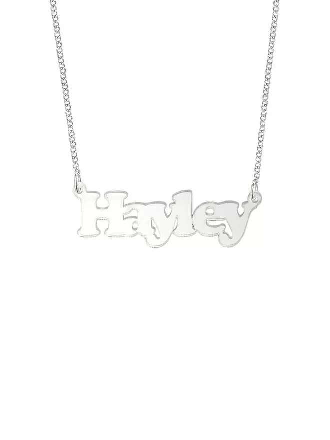 Personalised Name Neckace from Tatty Devine. The Necklace is the word Hayley laser cut from Deluxe Silver Mirror Acrylic on a silver-plated chain.