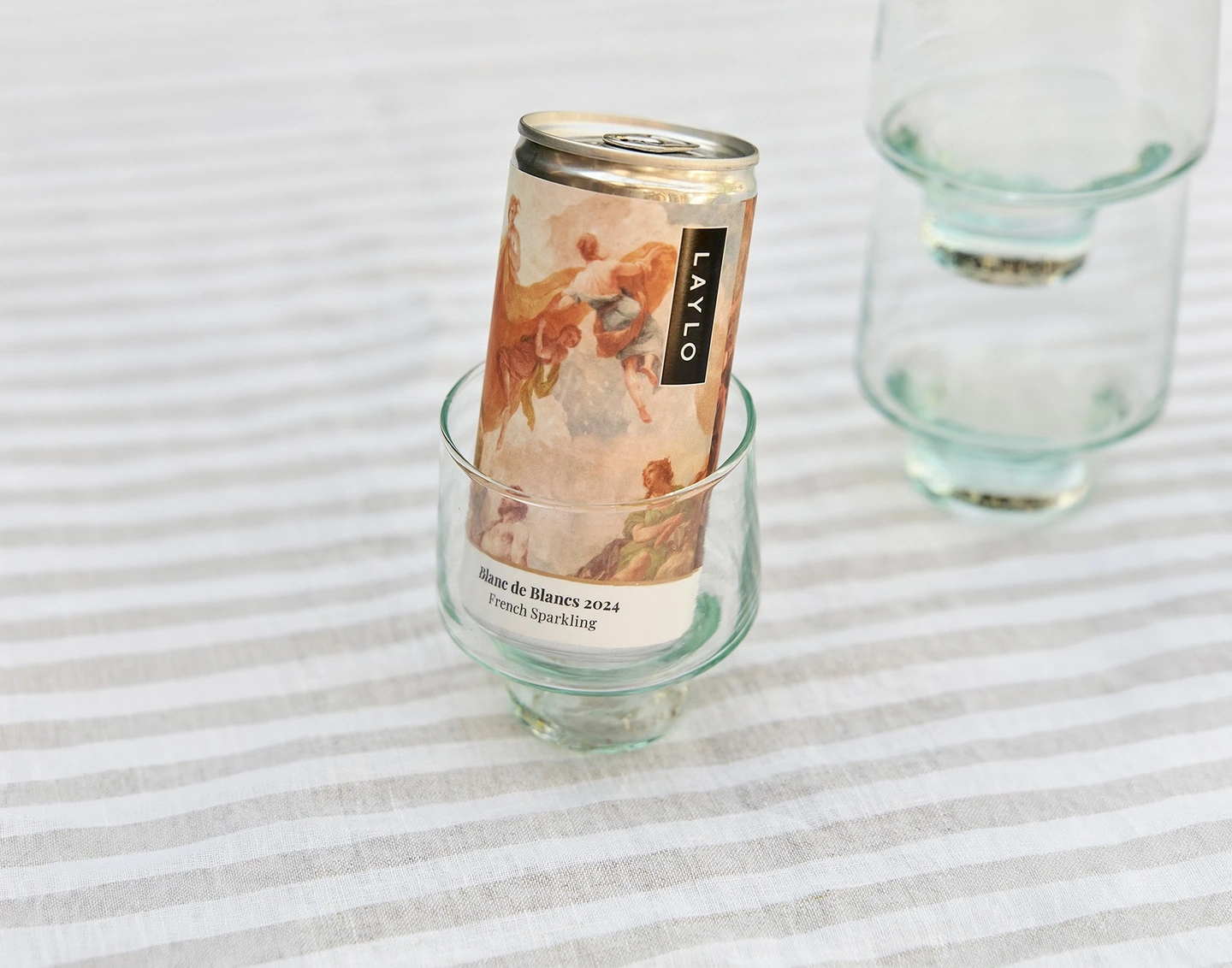 Canned wine with painterly packaging in a wine glass 