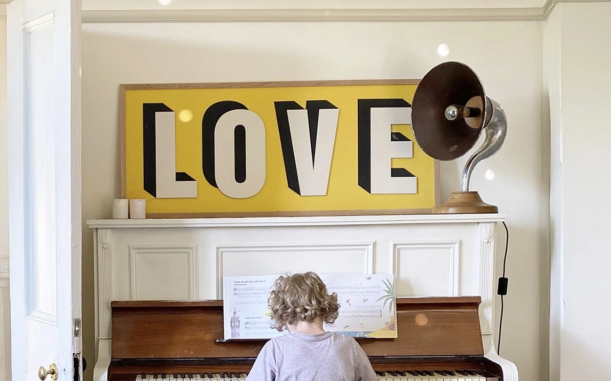 Wooden large Love sign. A large sign with a yellow background and the word love on the front