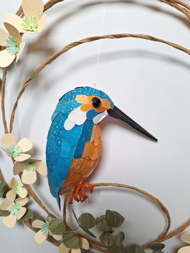 paper sculpture wall hanging, featuring a kingfisher on a floral wreath