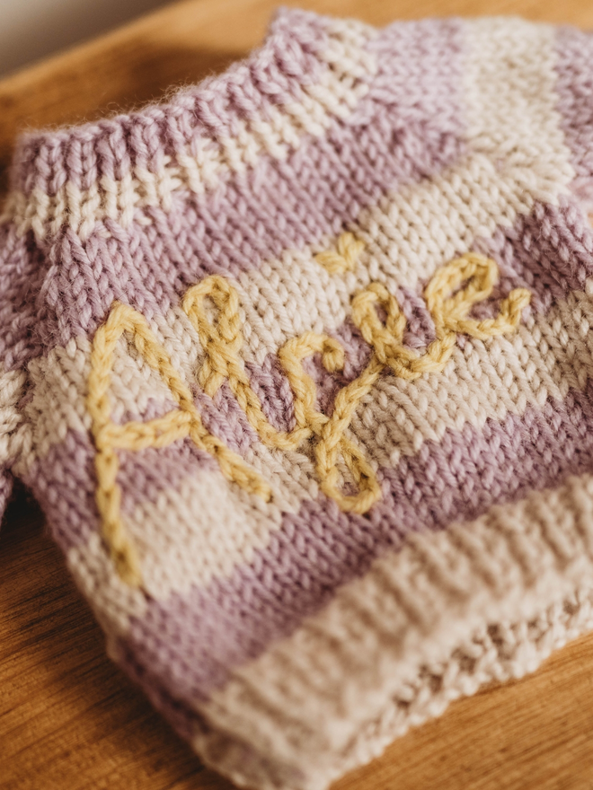 hand knit purple and white striped personalised jumper close up