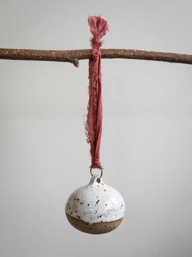 Half Dipped Flecked Christmas Bauble hanging on a branch