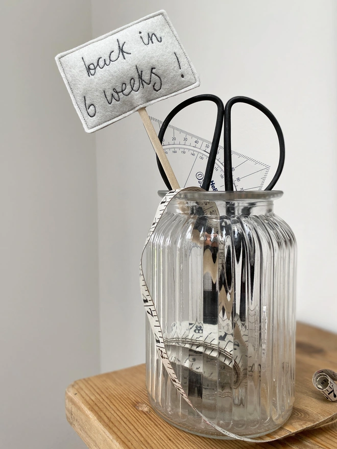 Teacher Thank You Embroidered Sign in glass vase with scissors