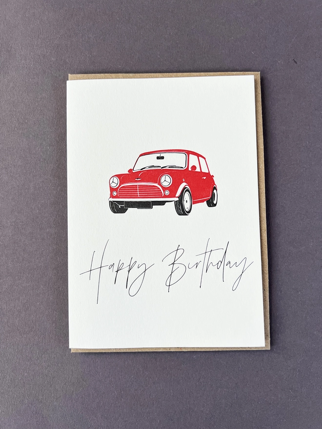 An old school red Mini with "Happy Birthday" beautifully written in modern calligraphy underneath.