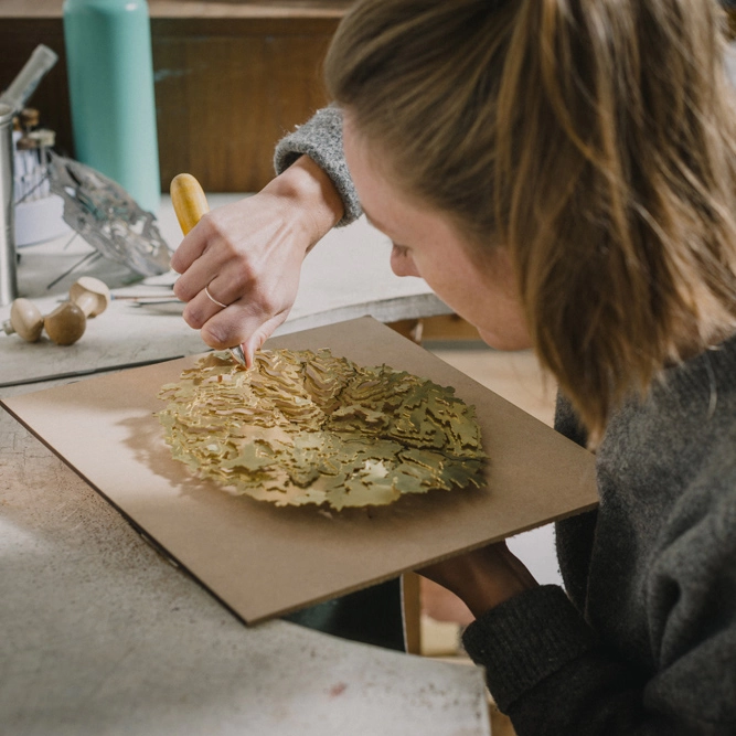 Holly working on a contour map piece in the workshop