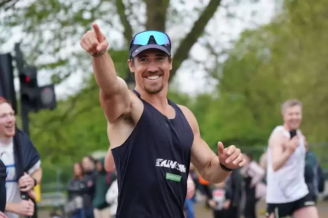 Josh Patterson, Ultra Athlete & Mental Health Campaigner, smiling and pointing past the camera.