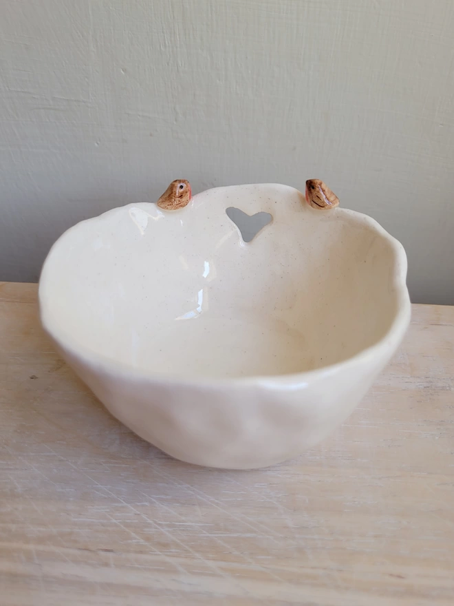 tea light candle holder in white earthenware ceramic with modelled 2 robin birds on the rim