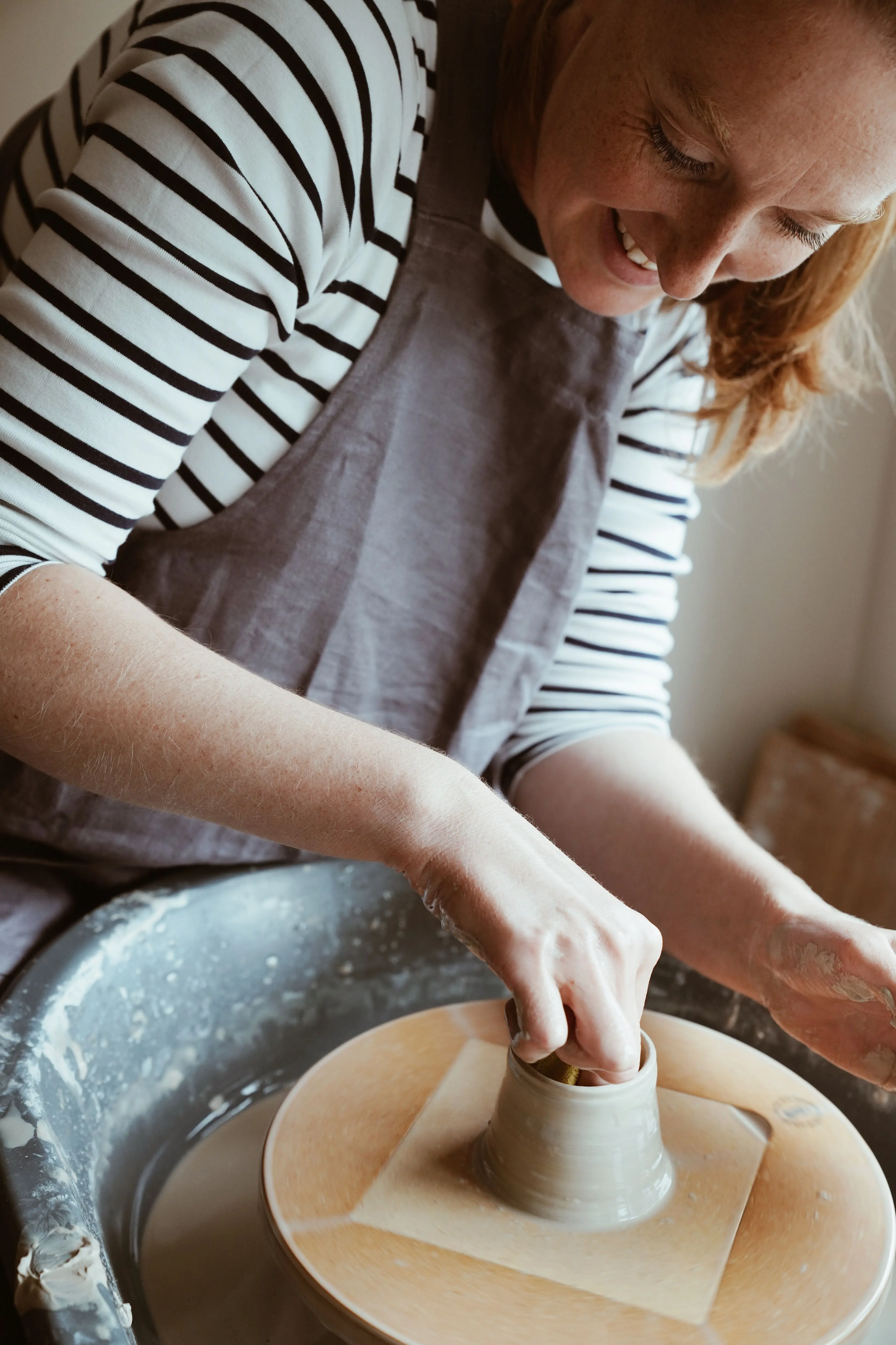 Faye Wellon making a match pot on her pottery wheel in her Herefordshire studio