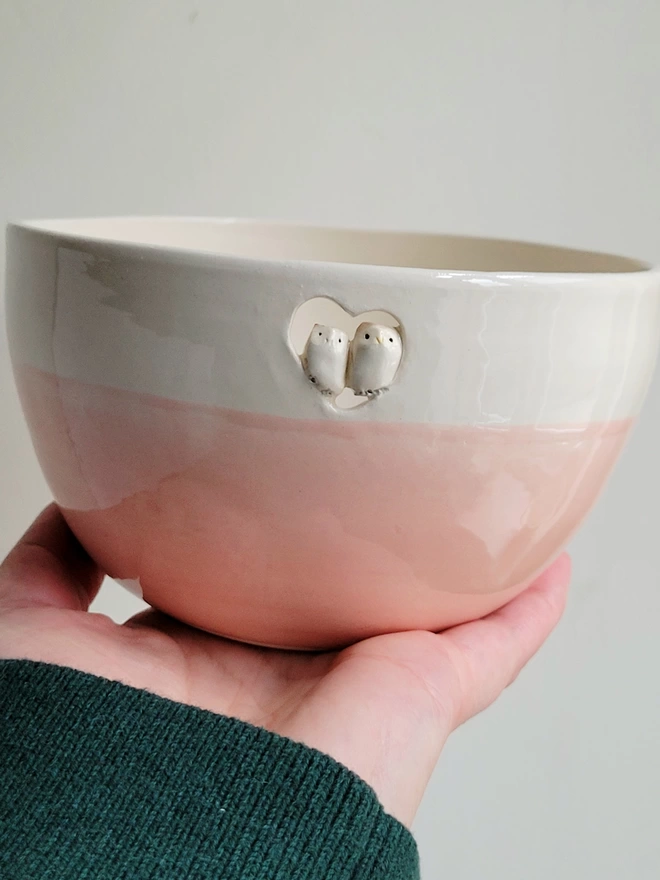 pink ceramic owl couple bowl being held in a hand with a tiny owl couple resting in a cut out heart
