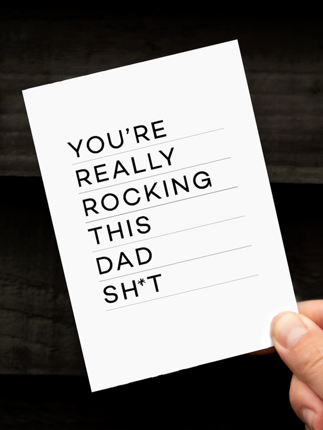Close up of a Rocking Dad Birthday Card on a black background.