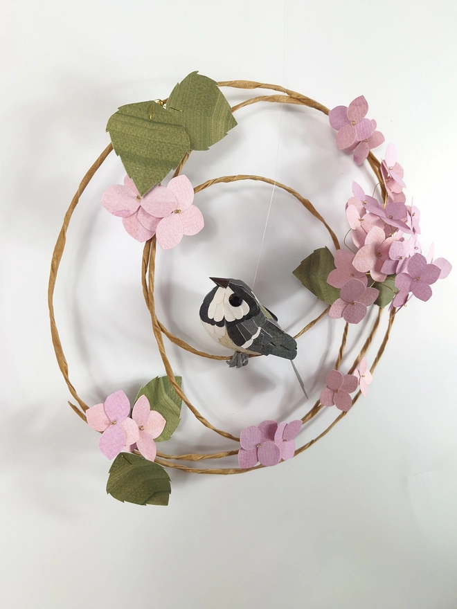 woodland wall art featuring a handmade sculpture of a coal tit bird, perched on a pink hydrangea wreath