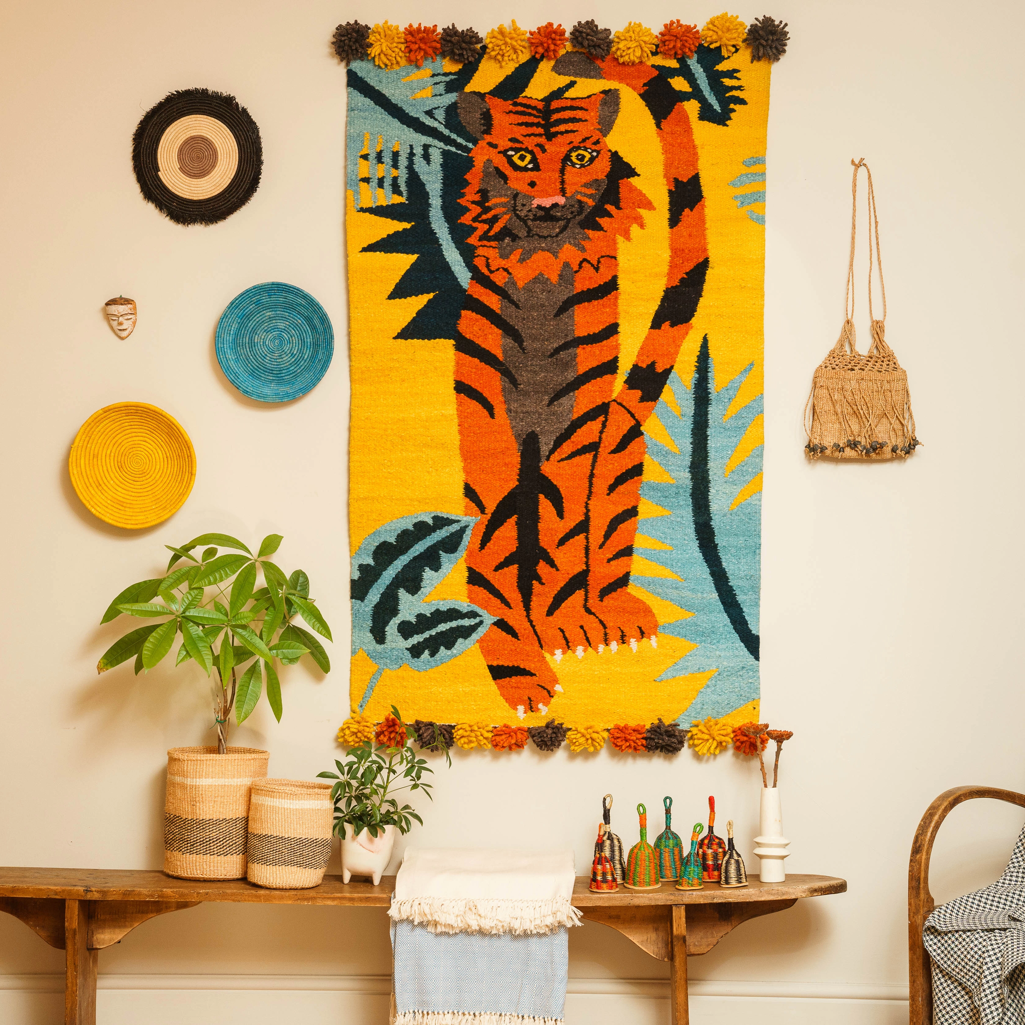 AARVEN Art wall featuring Tiger wall hanging, hand woven baskets and African crafts