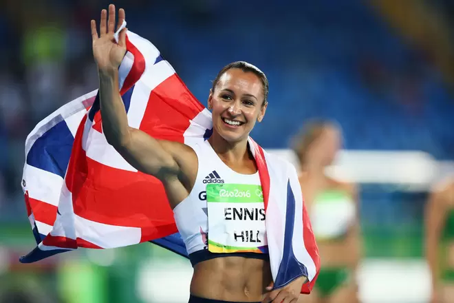 Jessica Ennis-Hill, olympic champion and fintech entrepreneur, smiling into the distance with a british flag around her shoulders.