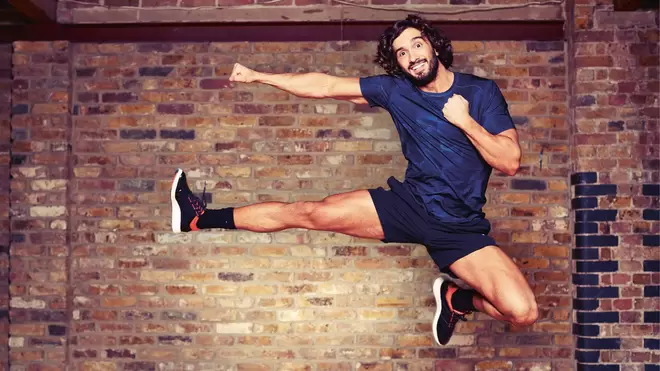 Joe Wicks MBE, founder of The Body Coach, jumping in the air and smiling at the camera.