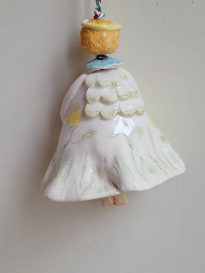 ceramic angel bell painted with buttercups showing the back view 