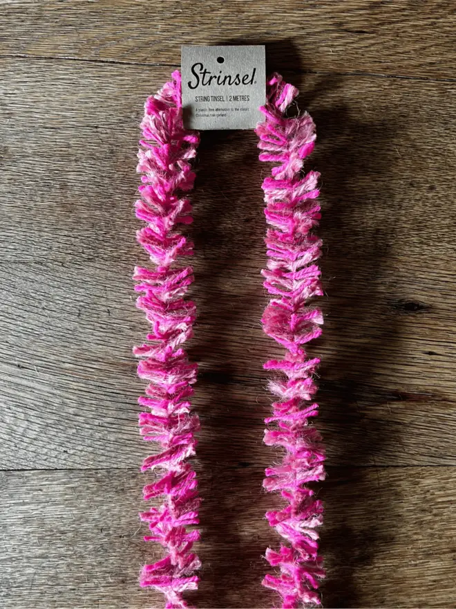 Pink Pop Strinsel draped on an oak table