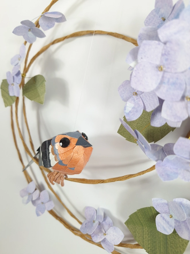 blue hydrangea floral wreath with a chaffinch sculpture