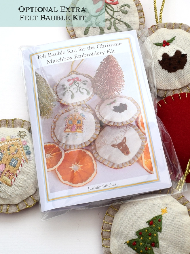 The Felt Bauble kit shown alongside a few finished embroidered felt baubles.