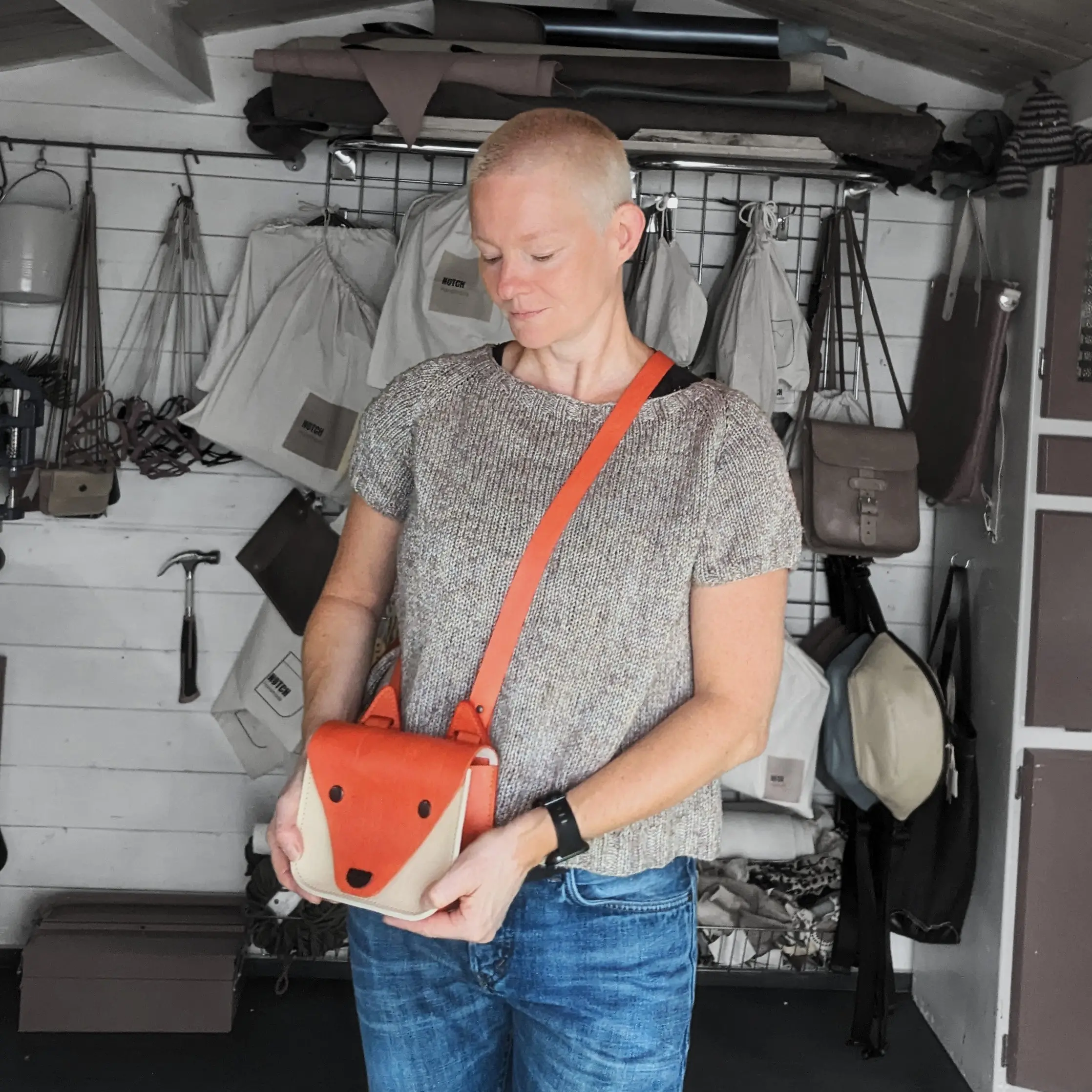 Portrait of Susan Barry of Notch handmade wearing hand- dyed leather 'Foxy' cross- body bag.