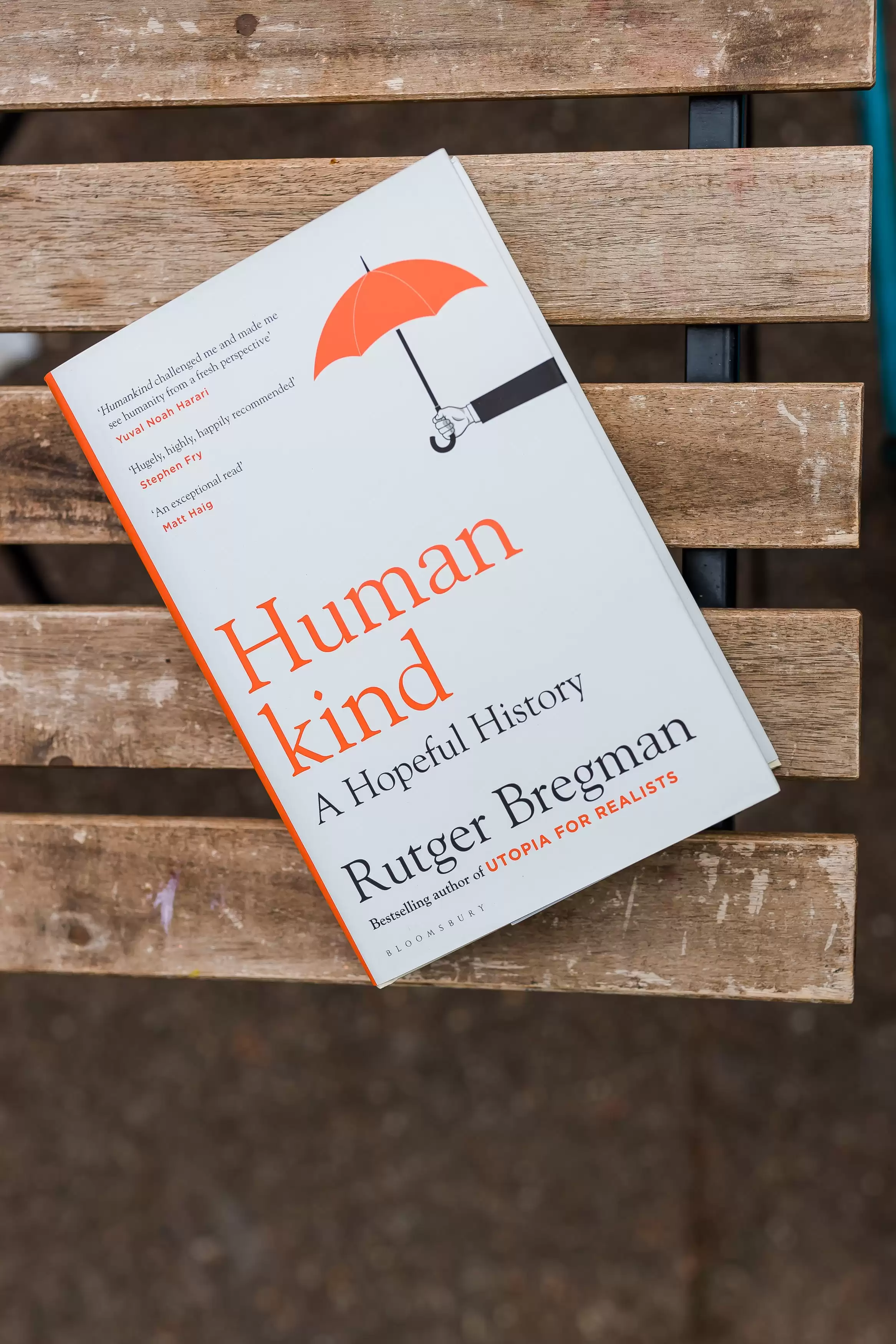 Human Kind Book by Rutger Bregman lay on a wooden bench