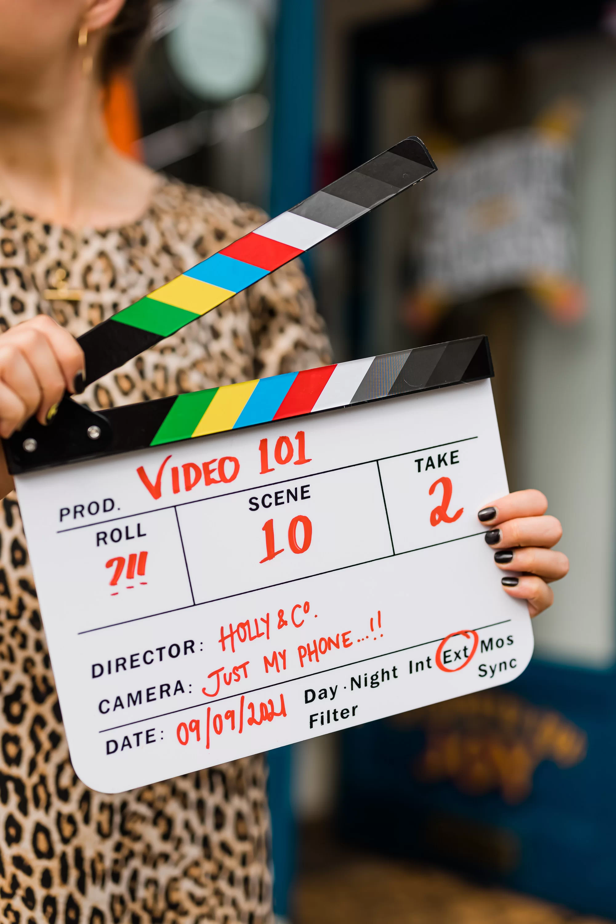 Woman holding a video 101 clapperboard 