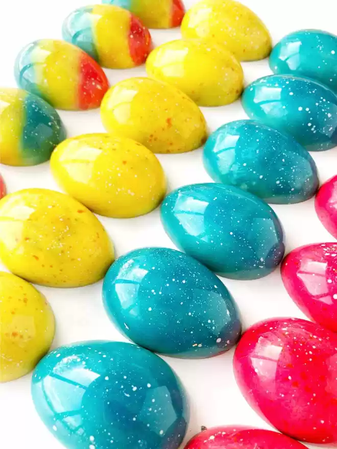a row of colourful easter eggs on a marble surface