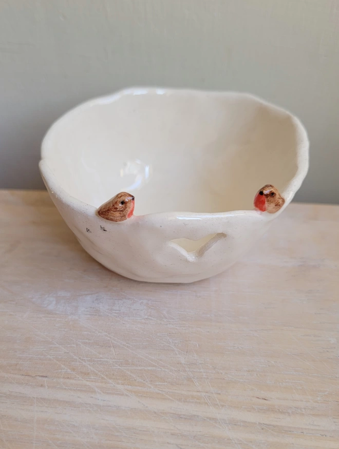 white pottery tealight holder with robin couple and heart cut out