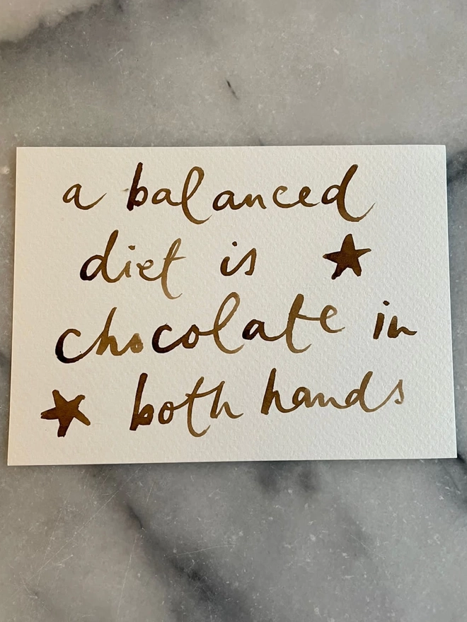 Gift Card, Balance is chocolate in both hands, with stars